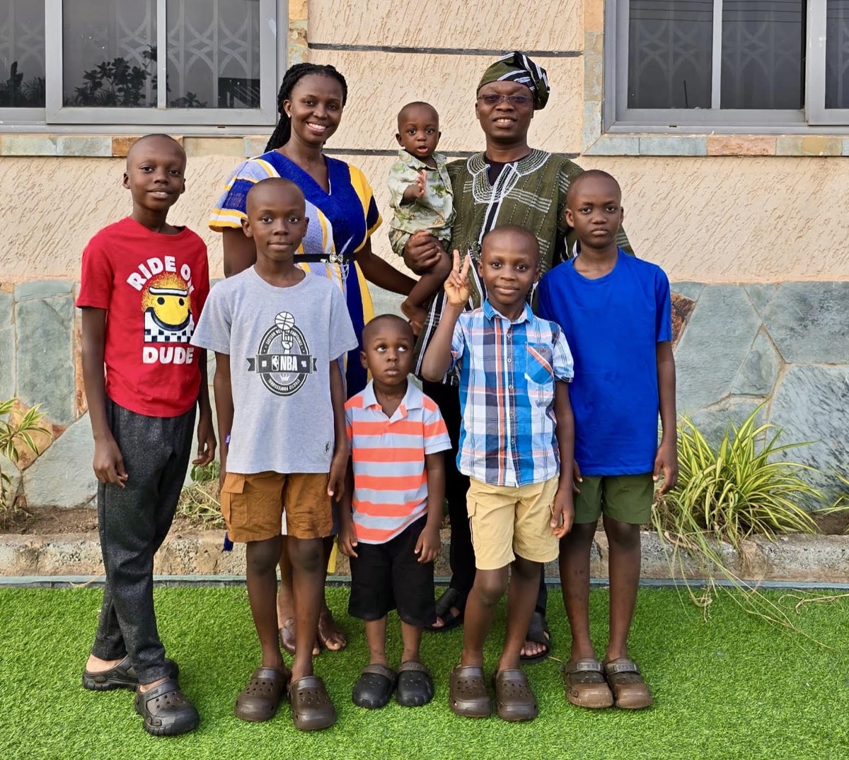 Ernest Gyampoh and his wife with their six children outside their home